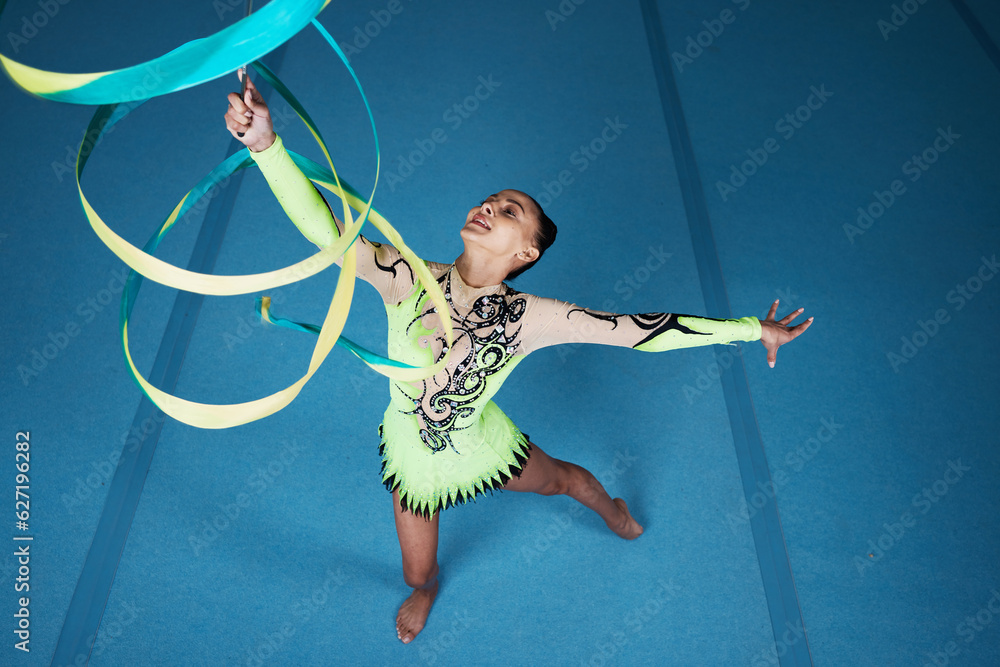 Dance, rhythmic gymnastics and woman in gym with ribbon in air, action with performance top view and