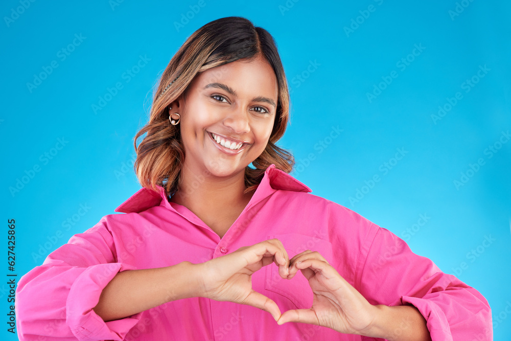 Woman, heart shape and smile portrait in studio for love, fashion or happiness. Happy person show si