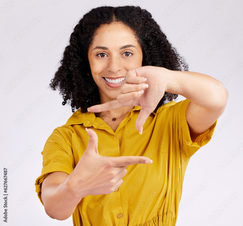 Happy woman, portrait and frame hands for photography, picture or creativity against a white studio 