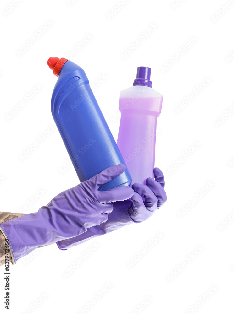 Young man with bottles of detergent on white background
