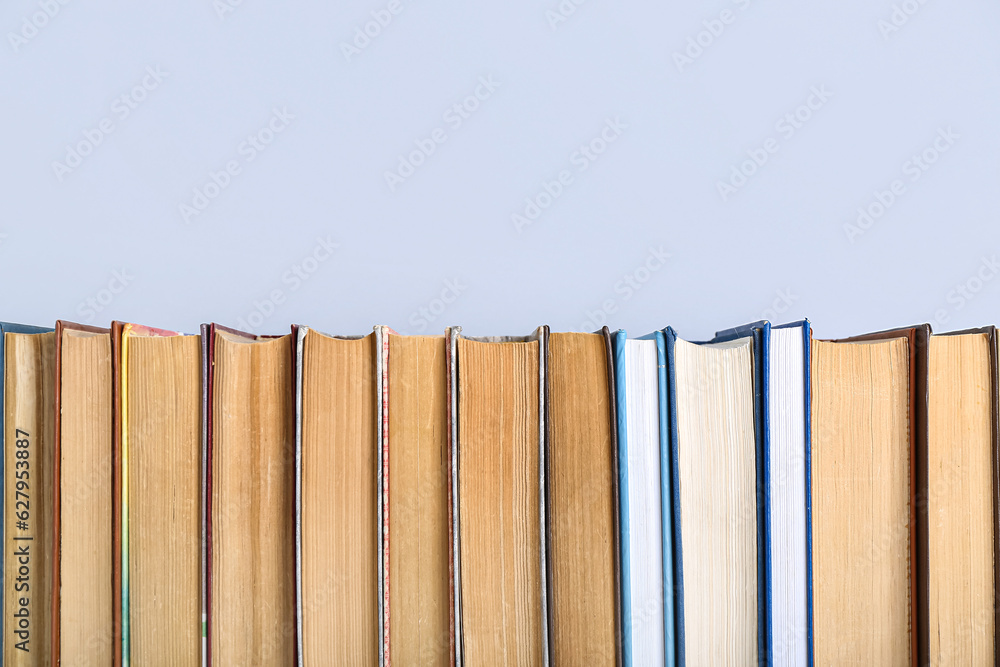 Row of books on grey background
