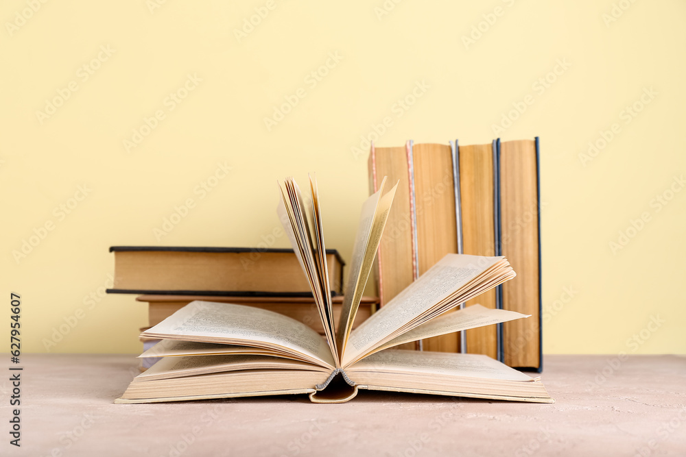 Books on table against beige background