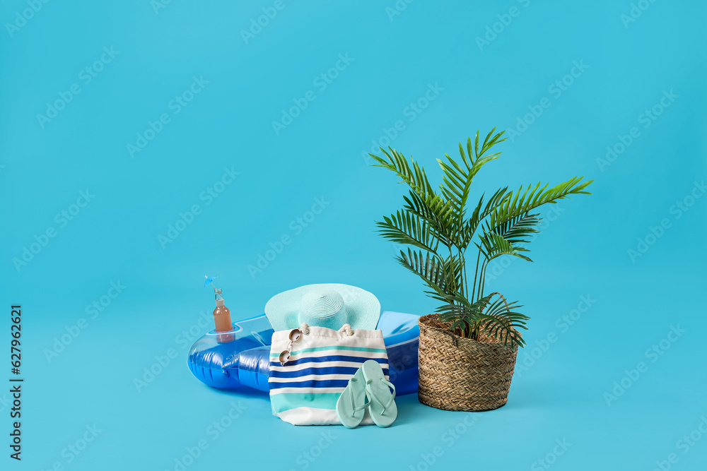 Beach accessories with palm on blue background