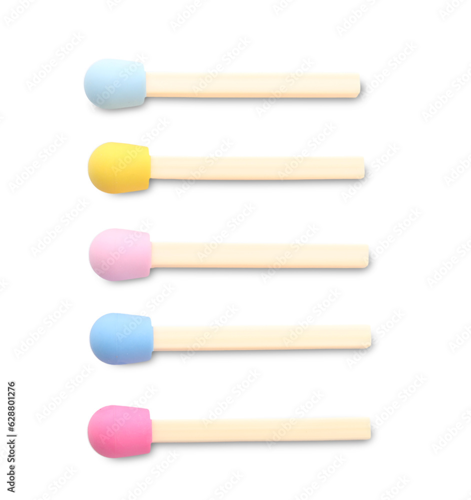 Set of erasers in shape of colorful matches on white background