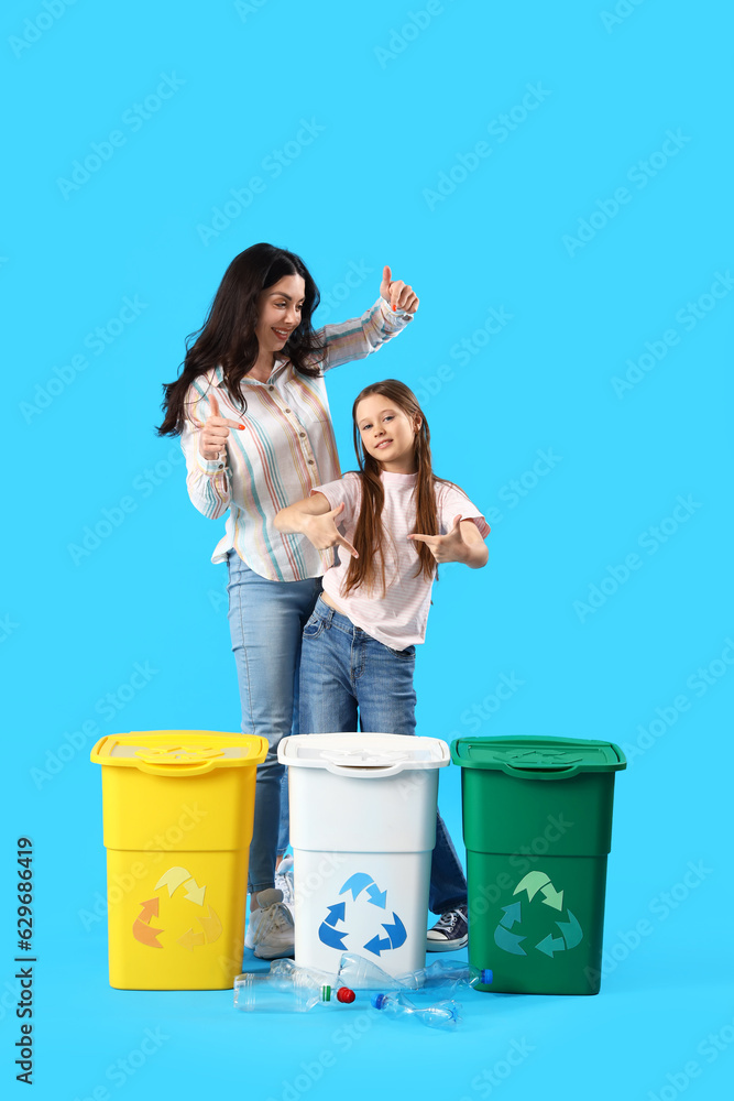 Little girl with her mother and recycle bins on blue background