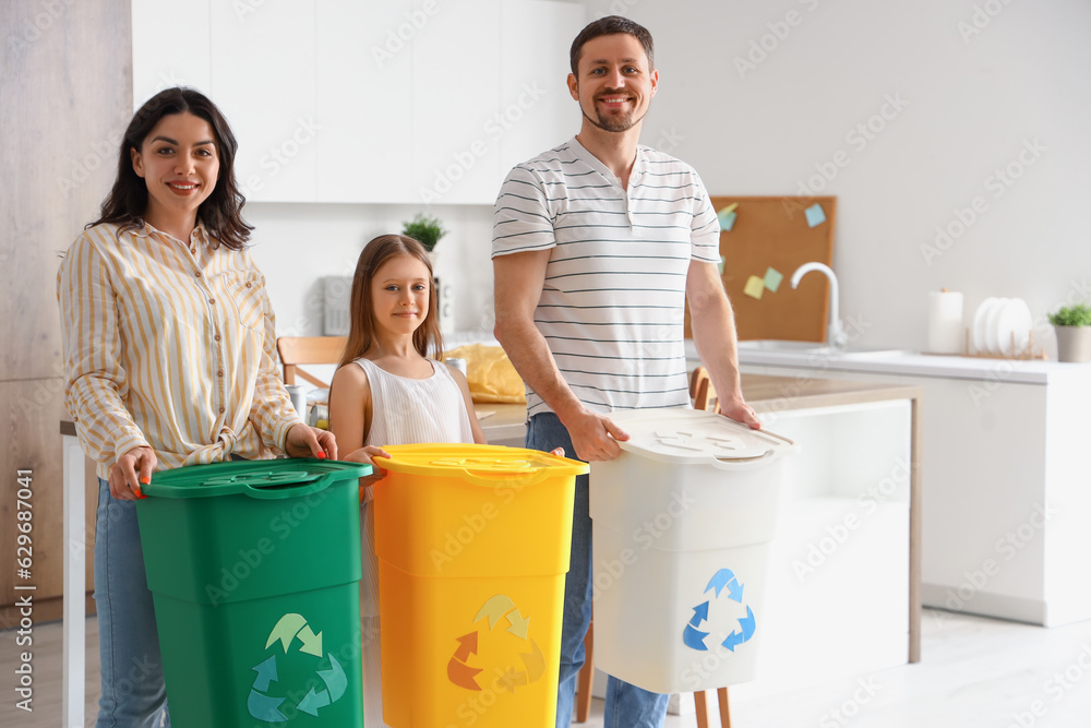 Family with recycle trash bins in kitchen