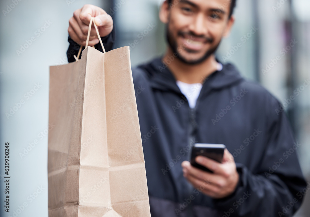 Courier man, giving paper bag and portrait with phone, smile and delivery service in supply chain jo