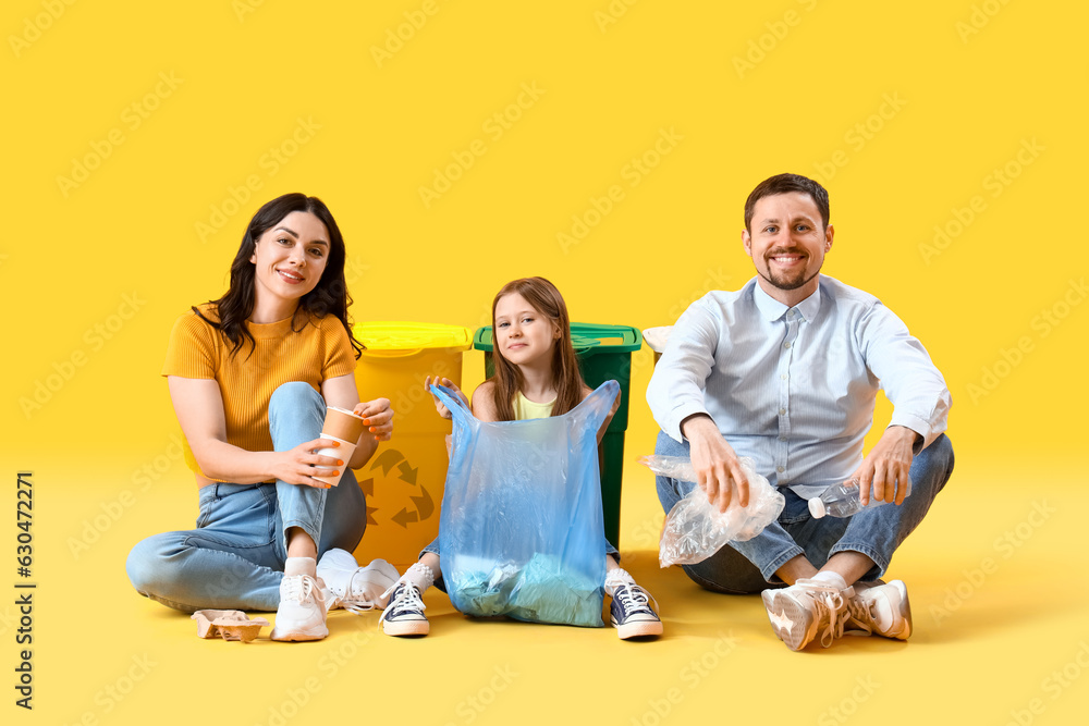 Family with garbage bag and recycle bins on yellow background