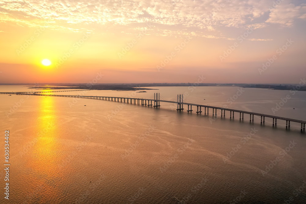 Aerial photo of Qingdao Jiaozhou Bay Cross Sea Bridge under sunset..