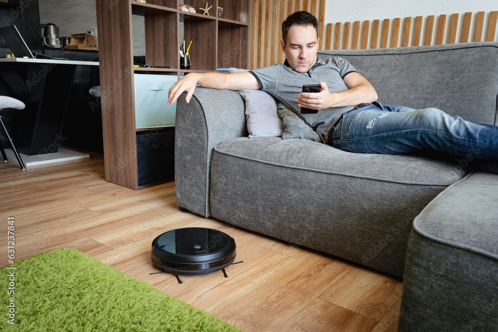 Remote control of robot vacuum cleaner via smartphone. Smart technologies at home. Internet of Thing