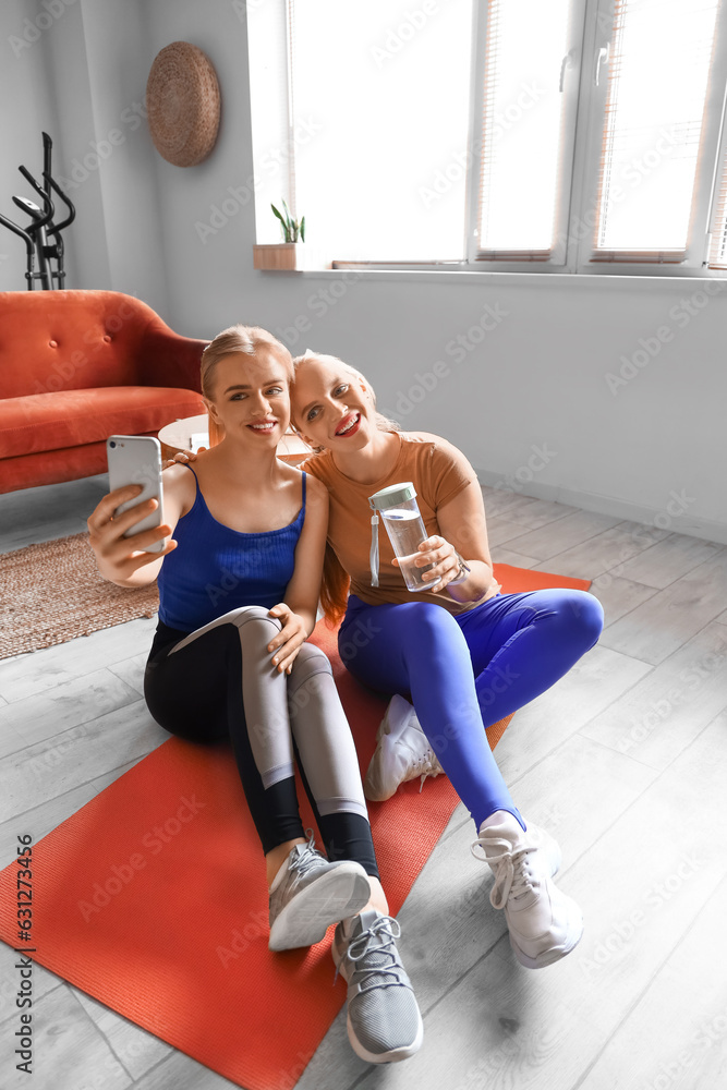 Sporty young women taking selfie during training at home
