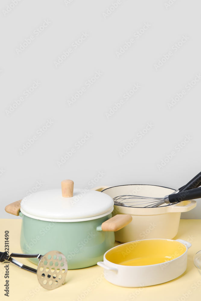 Set of different kitchen utensils on color background