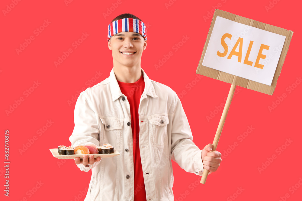 Young man holding tasty sushi and board with word SALE on red background