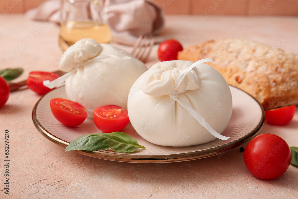 Plate with tasty Burrata cheese on beige background