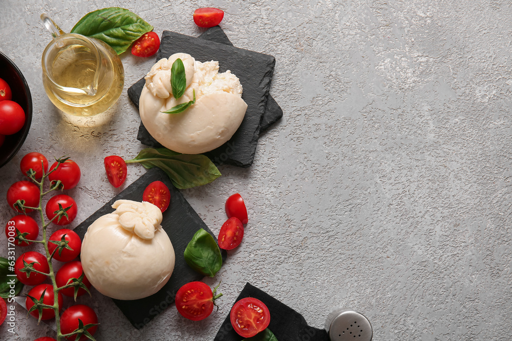 Tasty Burrata cheese with basil and tomatoes on grey table