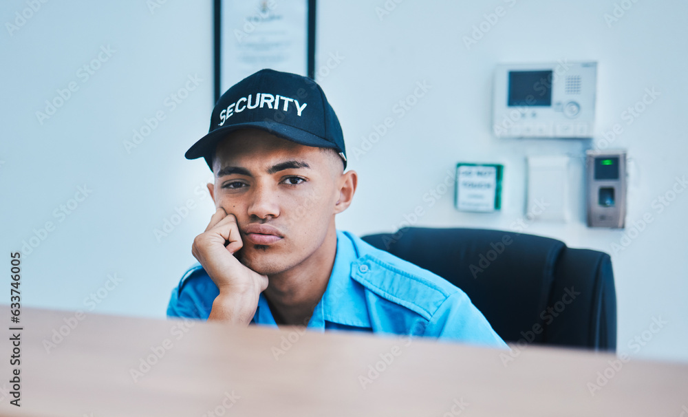 Portrait, surveillance and a bored man security guard sitting at a desk in his office to serve and p
