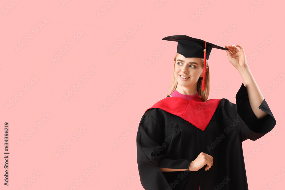 Female graduate student on pink background