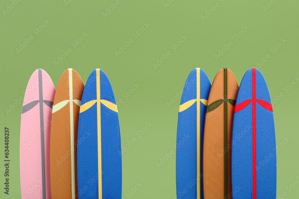 Different mini surfboards on green background