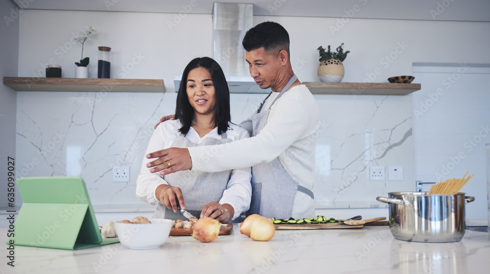 Digital tablet, cooking and couple in a kitchen, talking and bonding with love, marriage and fun act
