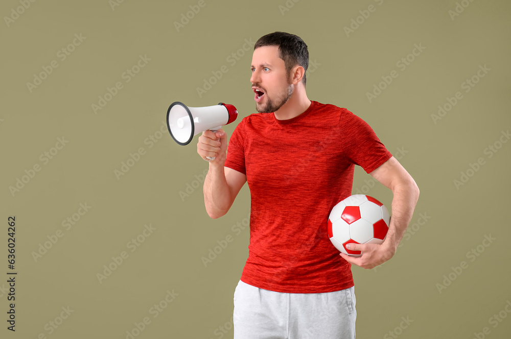 Man with soccer ball and megaphone on color background