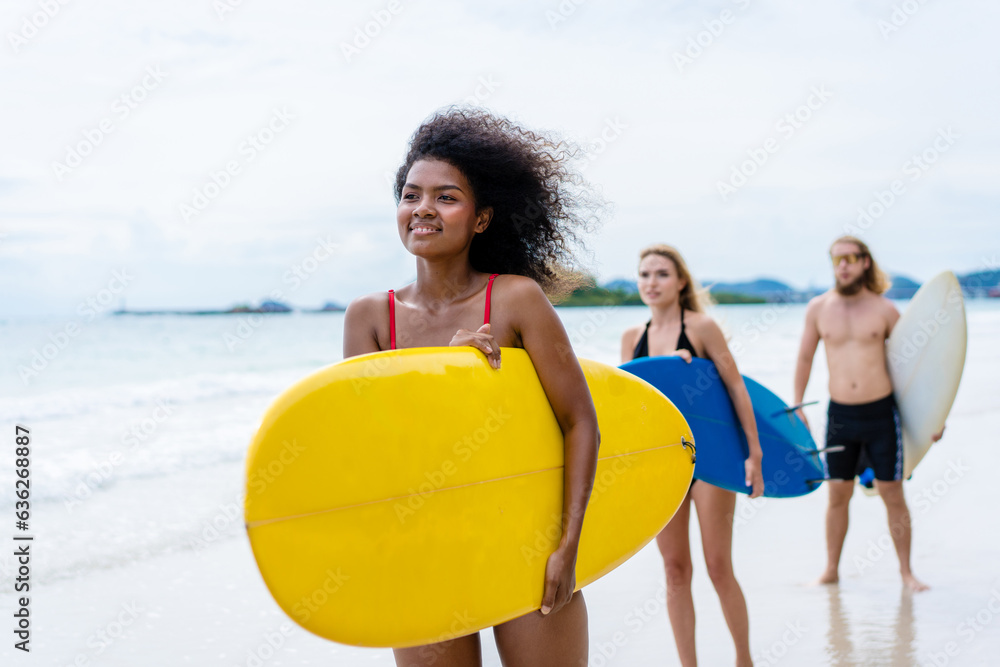 Group Friendship playing surfboard on the beach in weekend activity, Sport extreme healthy lifestyle