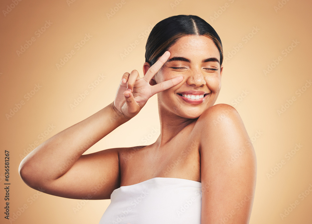 Woman, beauty and skincare with peace sign, studio and cosmetics with natural glow on face by backgr