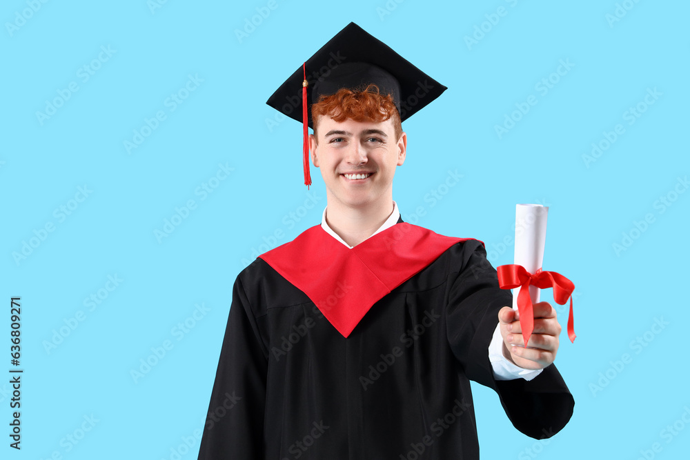 Male graduate student with diploma on blue background