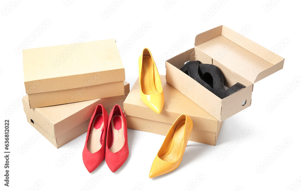 Cardboard boxes with different female shoes isolated on white background