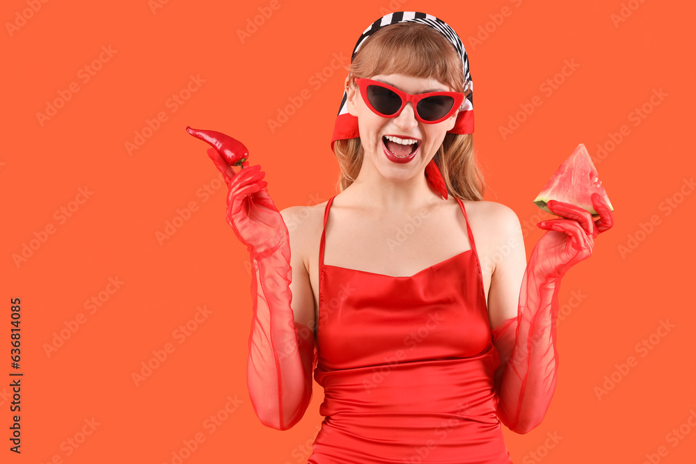 Young woman with fresh watermelon and chili pepper on red background