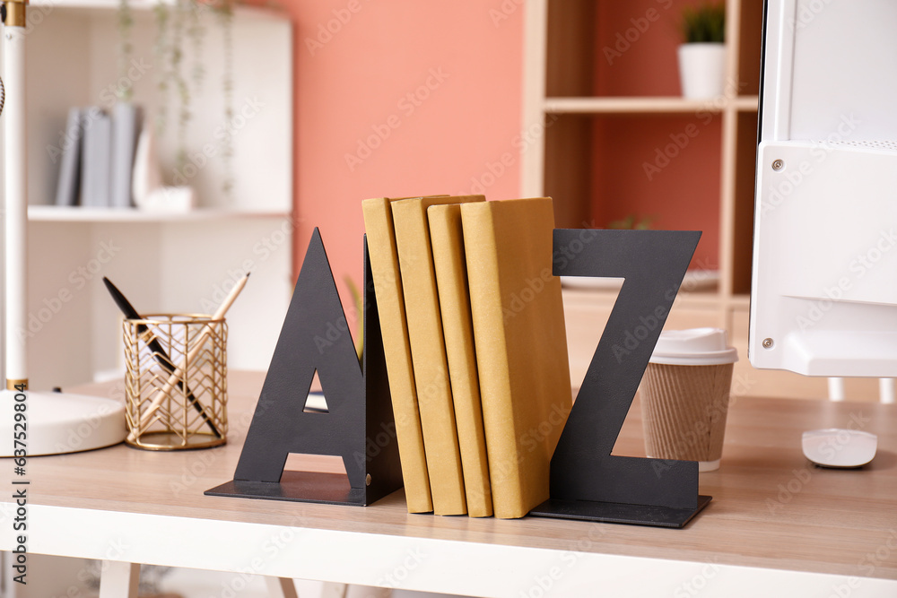 Stylish holder for books on wooden table in room