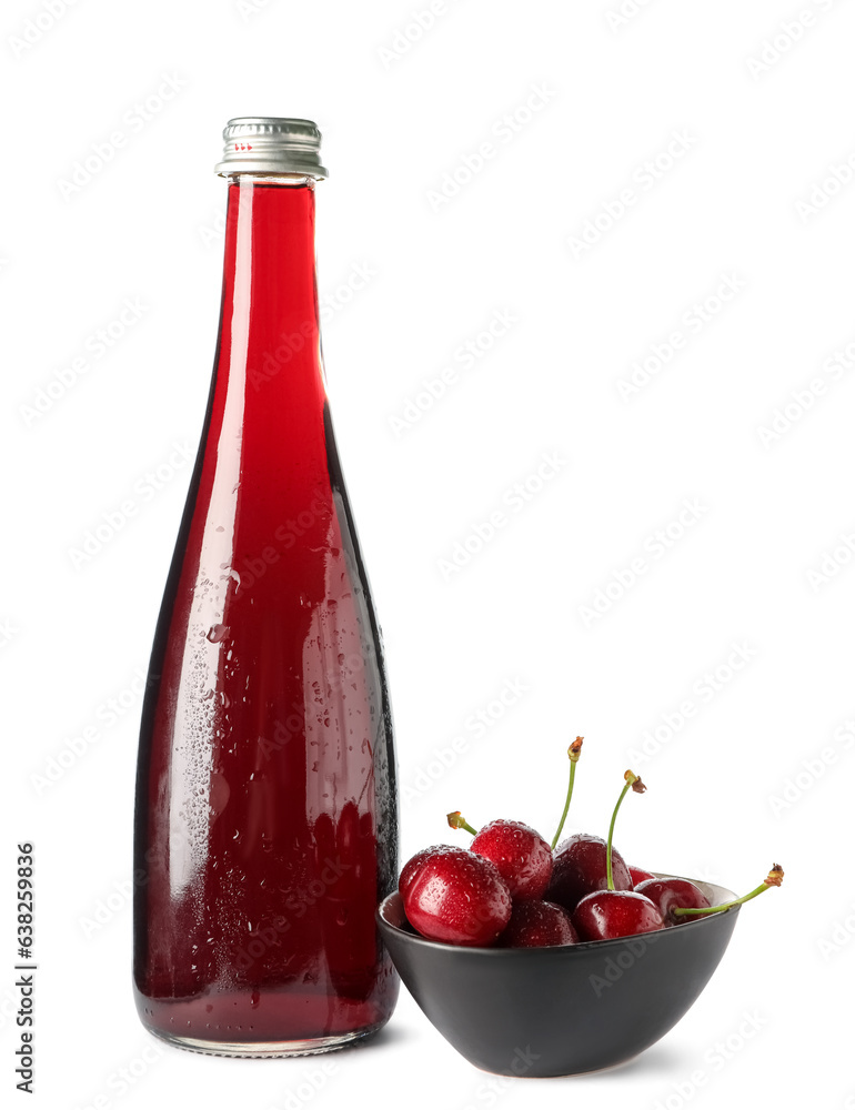 Bottle of sweet cherry liqueur and bowl with fresh berries on white background