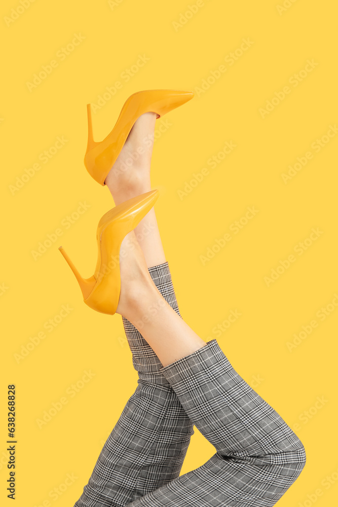 Woman in stylish high heels on color background, closeup