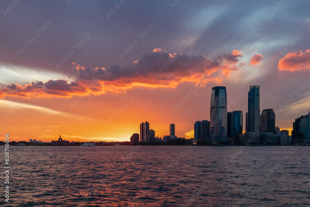 Breath-taking afterglow over New York City skyline and Hudson River at dusk. The sun goes down behin