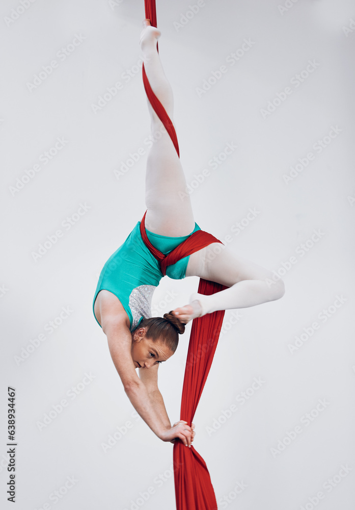 Gymnastics, aerial acrobat and silk with a woman in air for performance, sports and balance. Young a