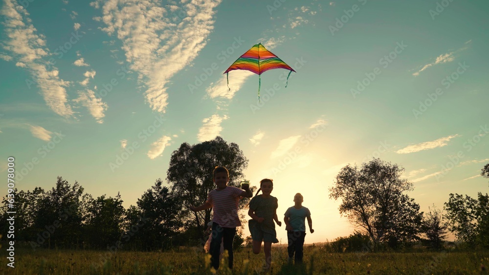 Boy girl, flying toy kite high in sky, childish emotions. Concept of childhood dream to fly. Childre