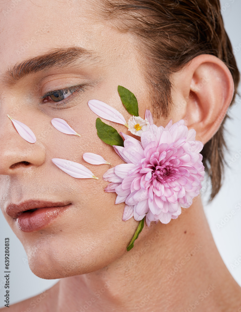 Natural, skincare and flowers on face of man in studio for spring, beauty cosmetics and creative. Gl