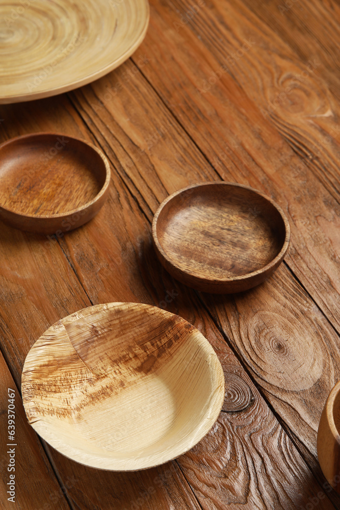 Plates and bowl on wooden background
