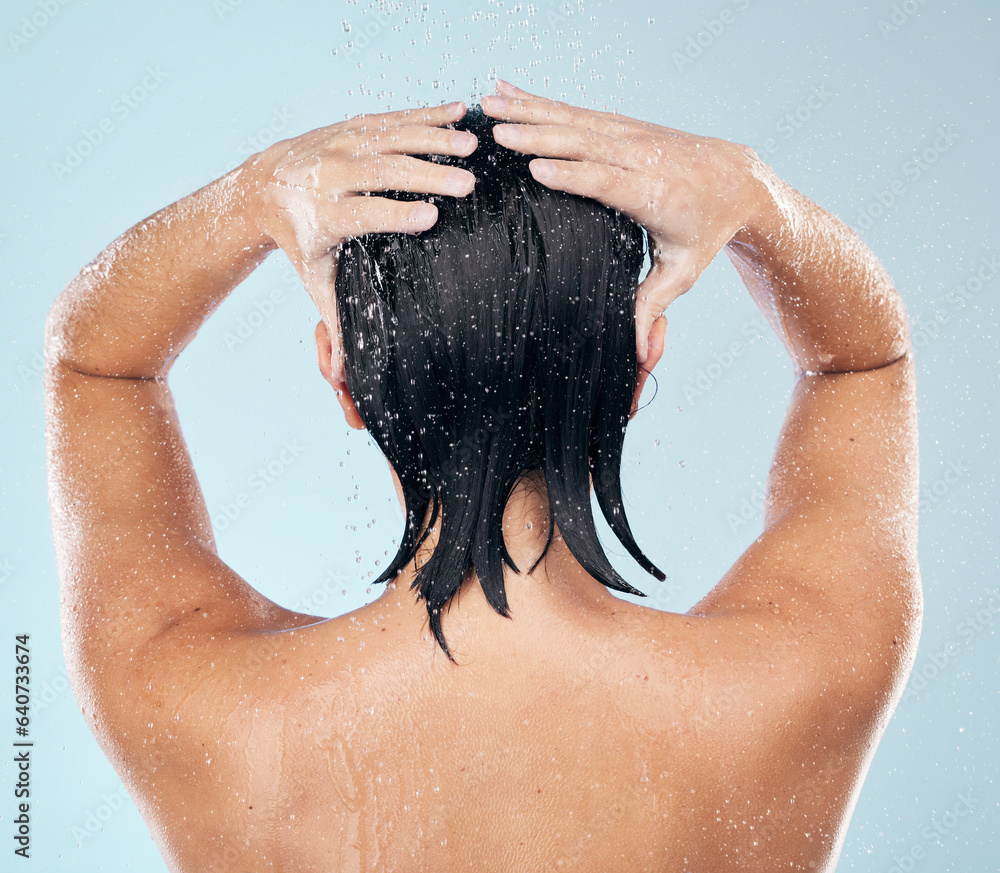 Hair care, shower and back of woman cleaning in studio isolated on a blue background. Water splash, 