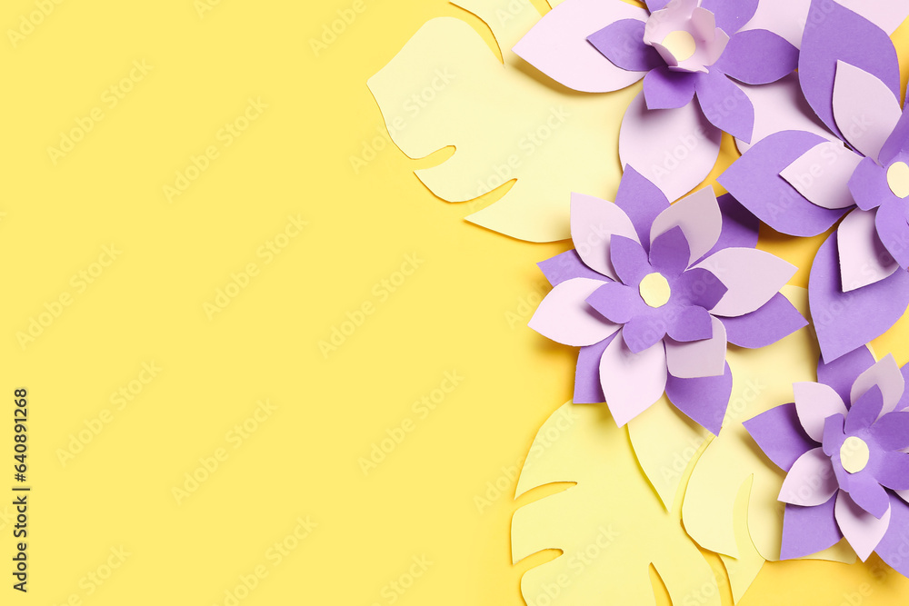 Colorful origami flowers with leaves on yellow background