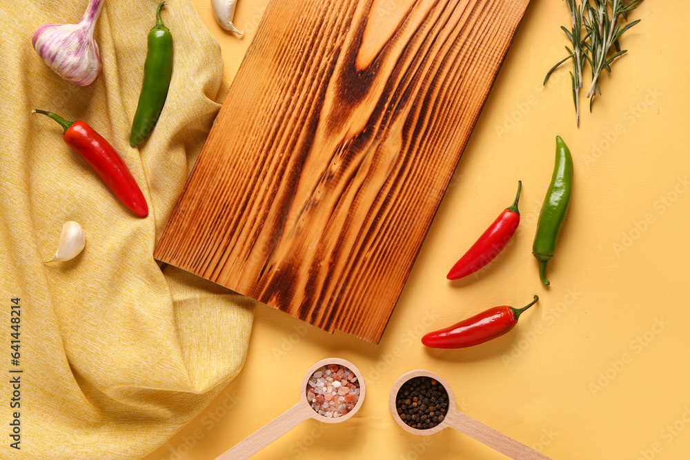 Composition with wooden cutting board, fresh spices and herbs on color background