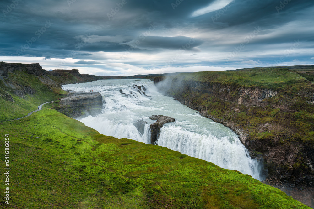 Gullfoss powerful waterfall flowing from Hvita river and moody sky in summer at Iceland