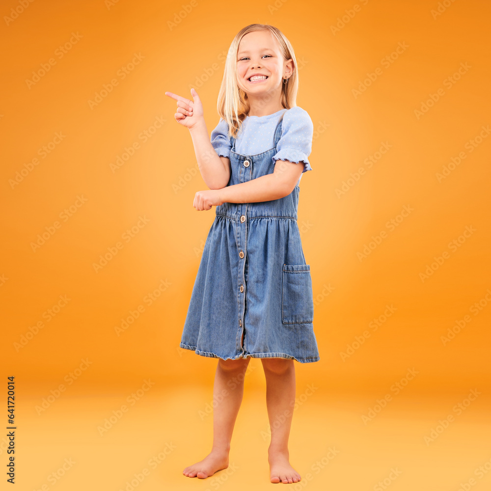 Pointing, happy portrait and child in studio for advertising, announcement or promotion. Excited bar