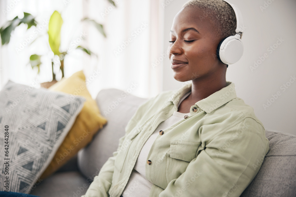 Black woman, listening and meditation podcast on headphones in home, living room or peace on sofa in