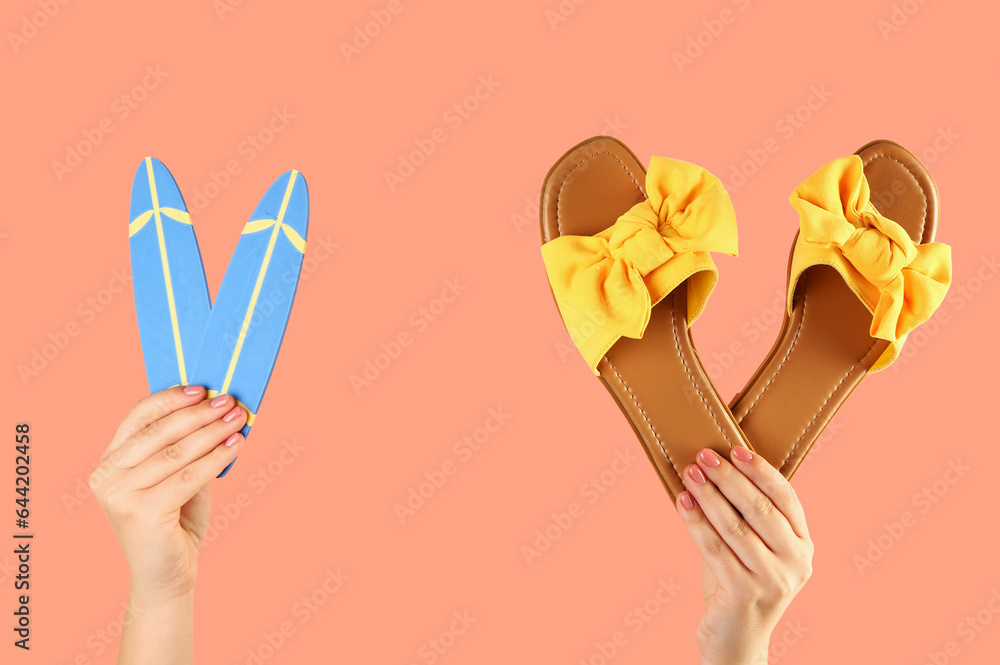 Female hands with mini surfboards and flip flops on red background