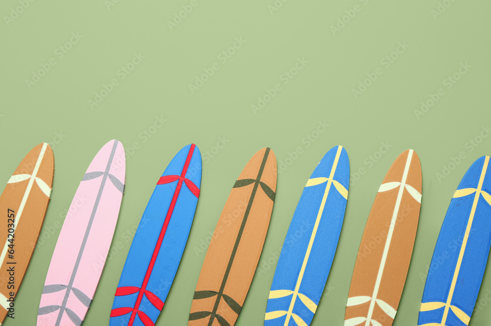 Different mini surfboards on green background