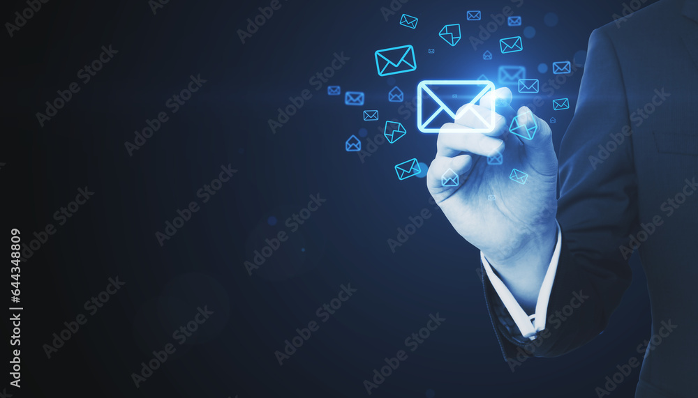 Close up of businessman hand with digital pen pointing at glowing email letter icons on dark blue ba