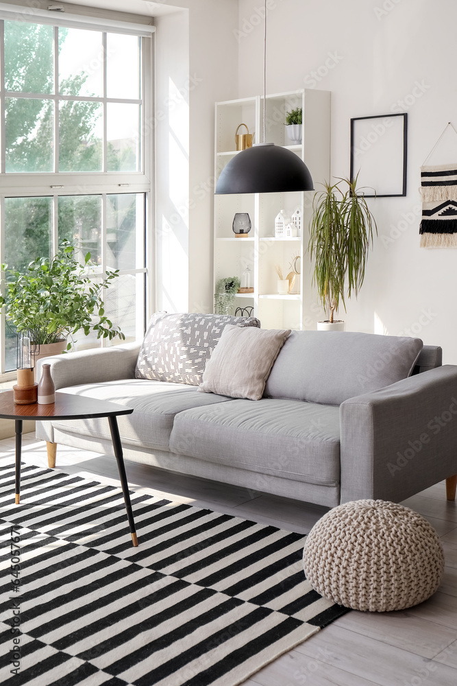Interior of stylish living room with grey sofa and coffee table