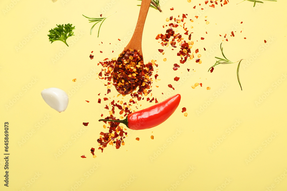 Flying spices and herbs on color background