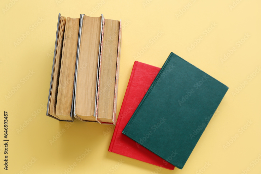 Stacks of books on yellow background