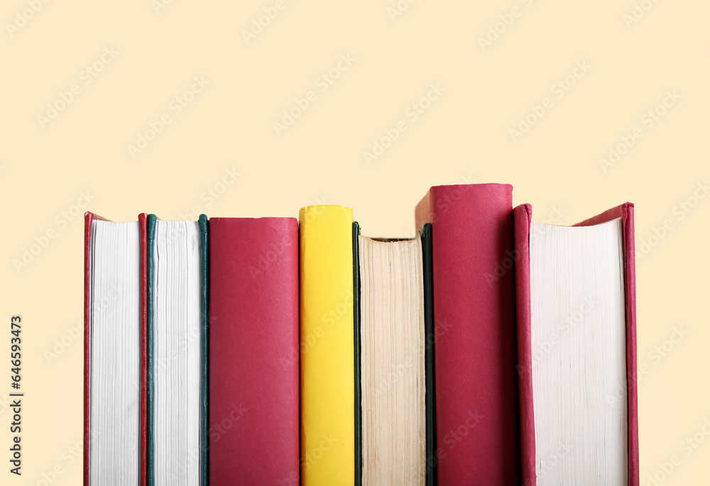 Row of books on beige background